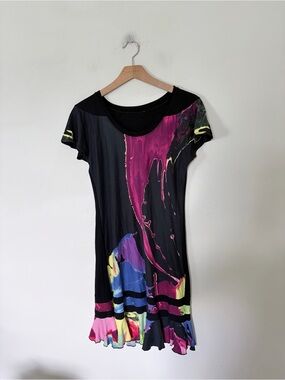 Vintage short-sleeve mini dress featuring a black base with a vibrant, abstract